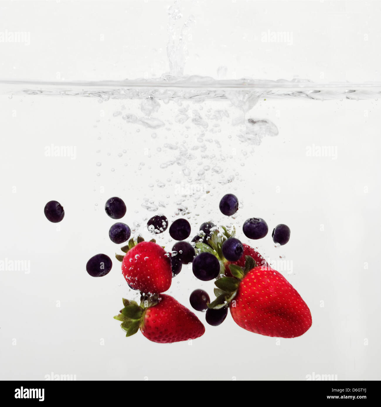Strawberries and Blueberries splashing into water Stock Photo Alamy