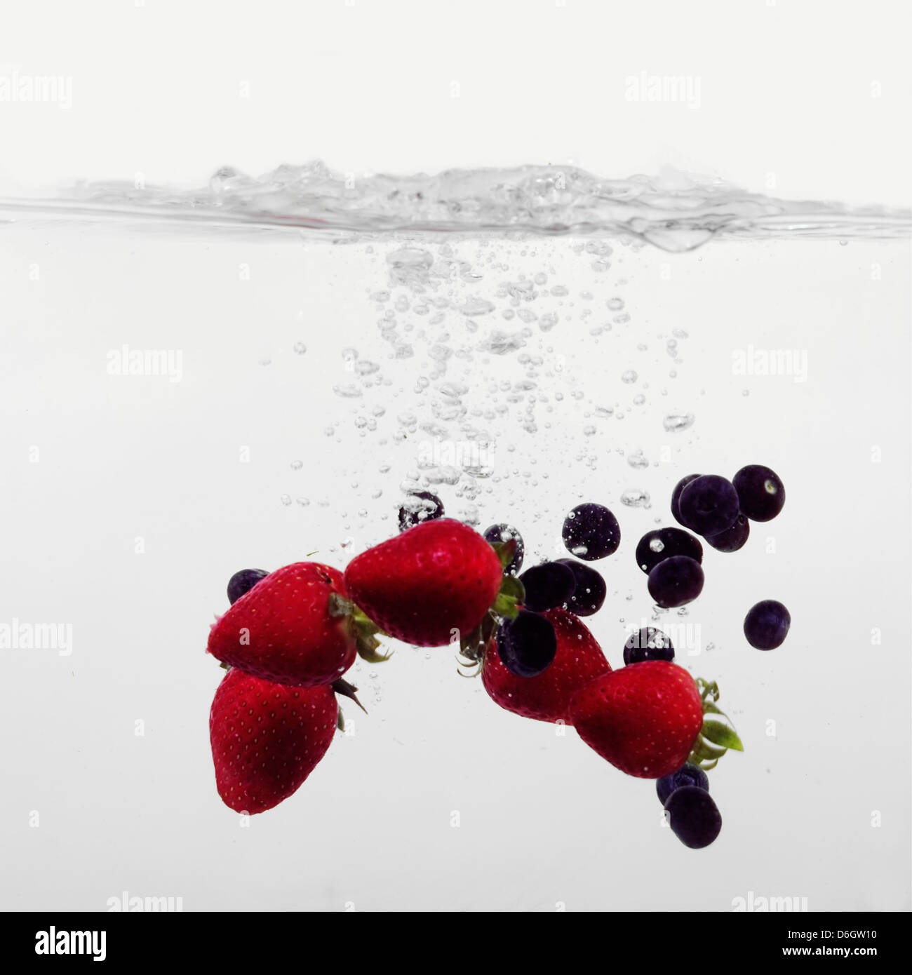 Strawberries and Blueberries splashing into water Stock Photo Alamy
