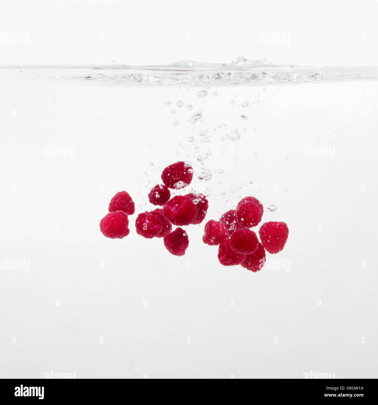 Raspberries splashing into water Stock Photo Alamy