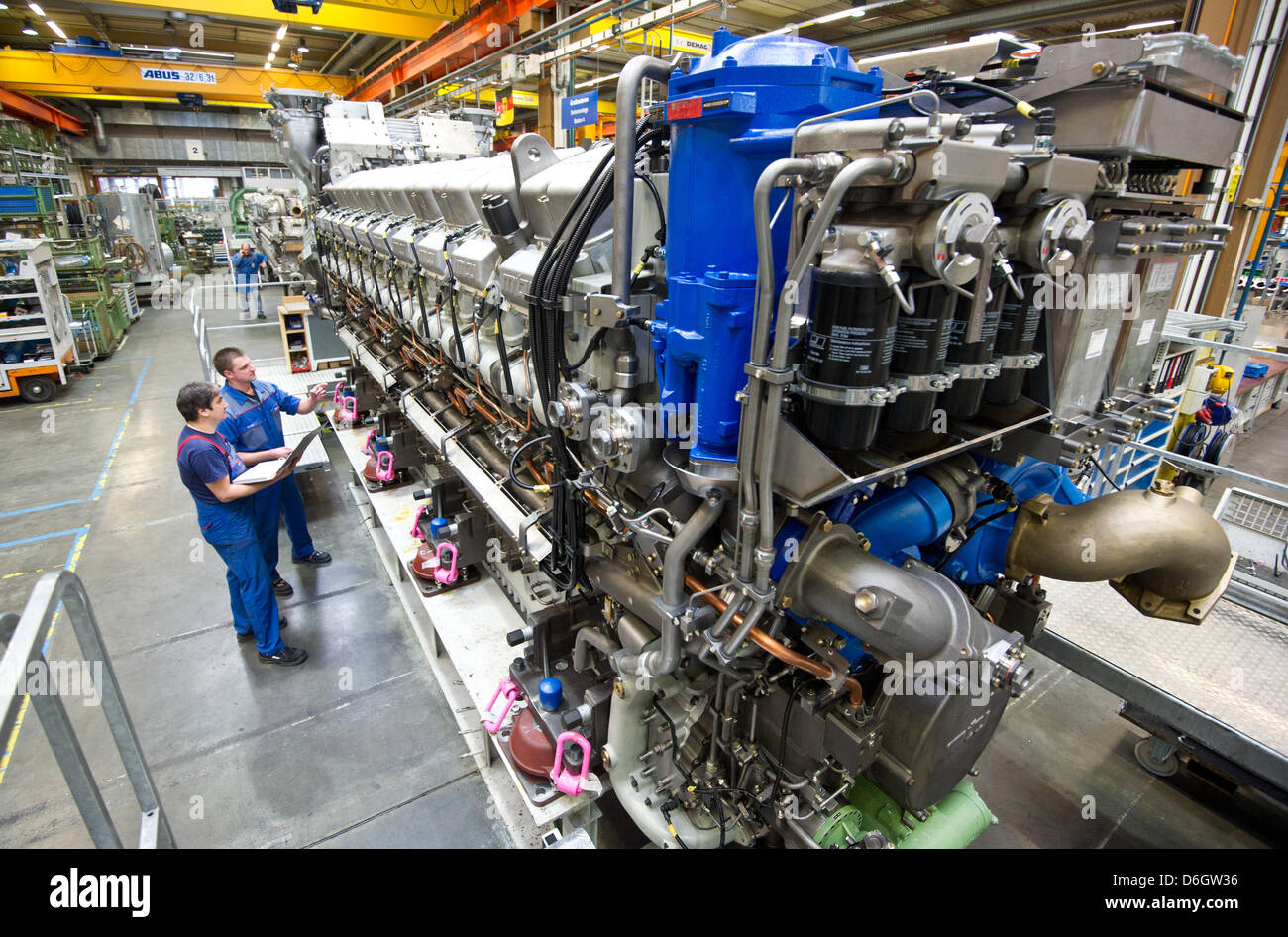 Two employees check an engine type 8000 at the MTU factory in Friedrichshafen, Germany, 25 January 2012. Photo: Tobias Kleinschmidt Stock Photo