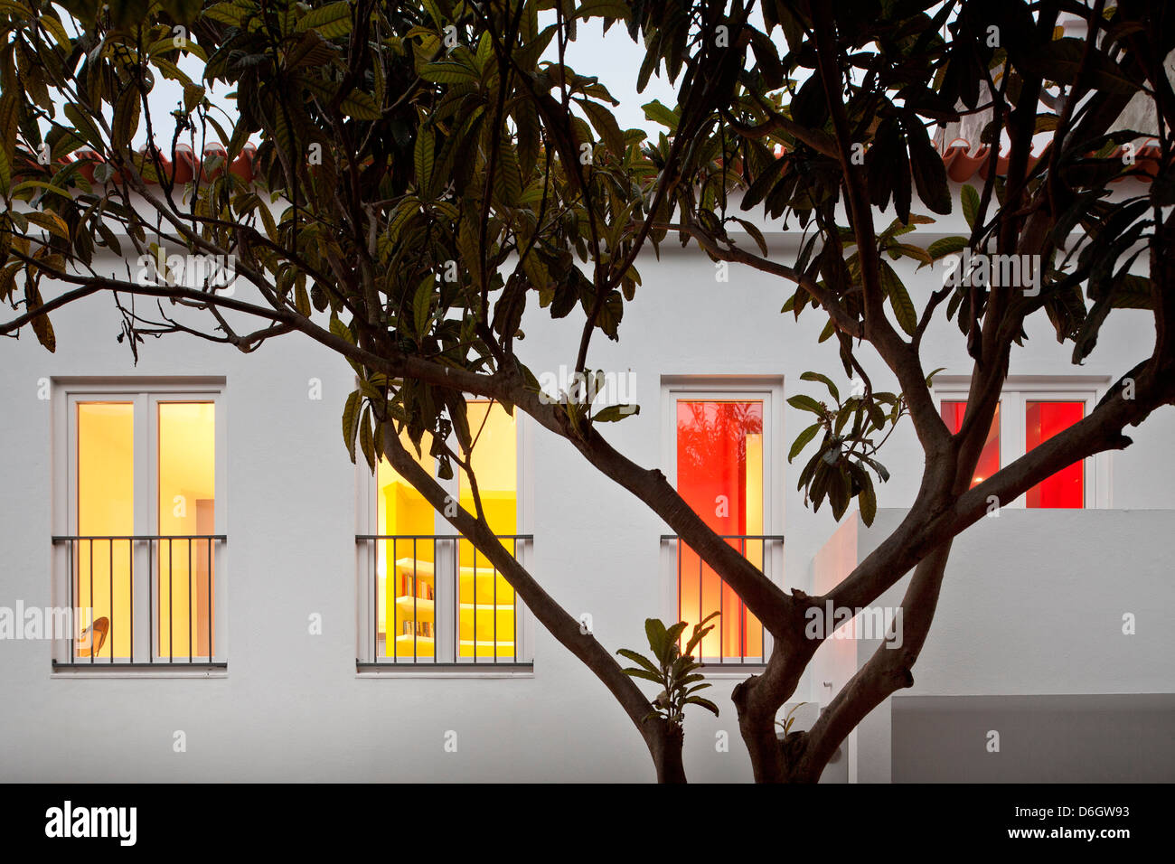 Casa em Almada, Almada, Portugal. Architect: Pedro Gadanho, 2012. Evening view of facade with lit interior. Stock Photo