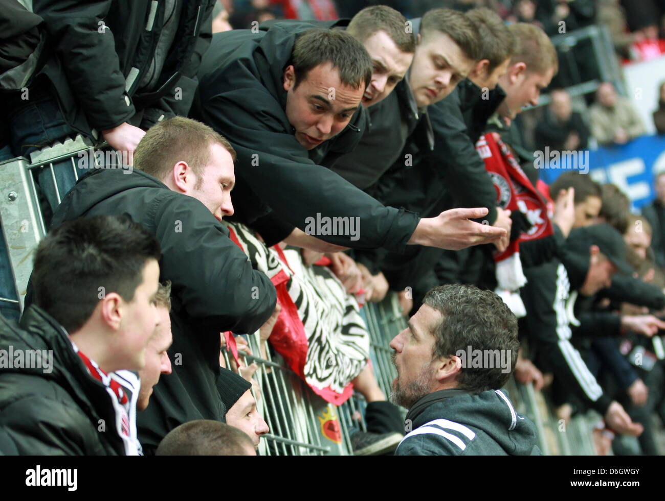 Kaiserslautern's head coach  Marco Kurz (R) talks to the fans after the German Bundesliga match between 1. FSV Mainz 05 and 1. FC Kaiserslautern at the Coface Arena in Mainz, Germany, 25 February 2012. Kaiserslautern lost 4-0. Photo: ROLAND HOLSCHNEIDER  (ATTENTION: EMBARGO CONDITIONS! The DFL permits the further utilisation of the pictures in IPTV, mobile services and other new te Stock Photo