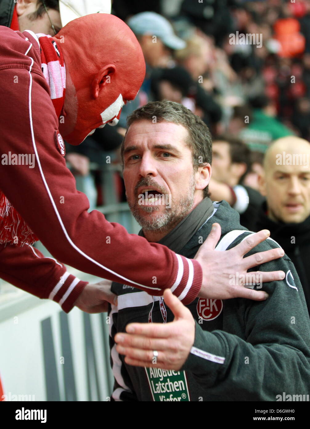 Kaiserslautern's head coach  Marco Kurz (R) talks to the fans after the German Bundesliga match between 1. FSV Mainz 05 and 1. FC Kaiserslautern at the Coface Arena in Mainz, Germany, 25 February 2012. Kaiserslautern lost 4-0. Photo: ROLAND HOLSCHNEIDER  (ATTENTION: EMBARGO CONDITIONS! The DFL permits the further utilisation of the pictures in IPTV, mobile services and other new te Stock Photo