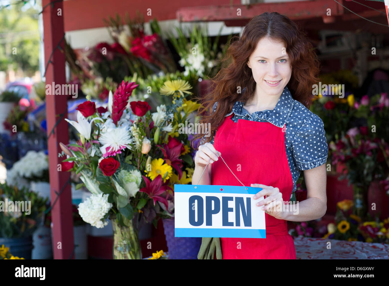Florist hanging open sign in shop Stock Photo