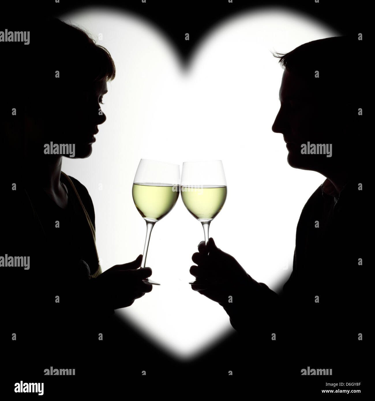 Silhouette Of A Couple Enjoying White Wine Framed In A Heart Stock Photo Alamy