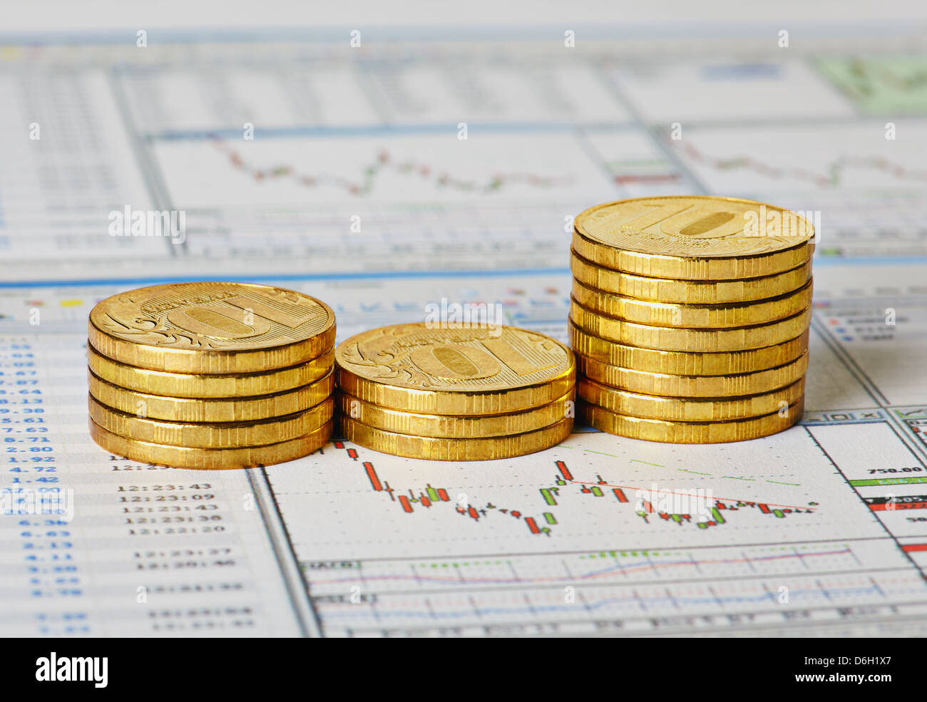 Financial settlement with the charts and golden coins. Selective focus Stock Photo