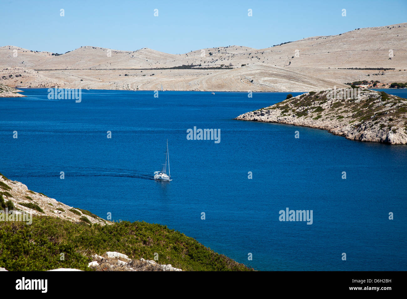 Sailboat on still lake Stock Photo