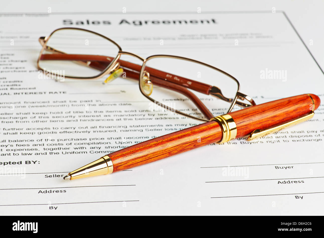 Contract with glasses and wooden pen ready to be signed. Selective focus Stock Photo