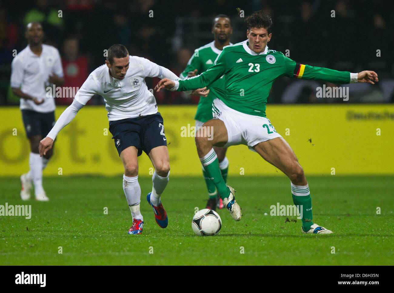 Germany's Mario Gomez (r) and Morgan Amalfitano of France fight for the ball during the international friendly soccer match Germany vs France at the Weser stadium in Bremen, Germany, 29 February 2012. Photo: Jens Wolf dpa/lni  +++(c) dpa - Bildfunk+++ Stock Photo