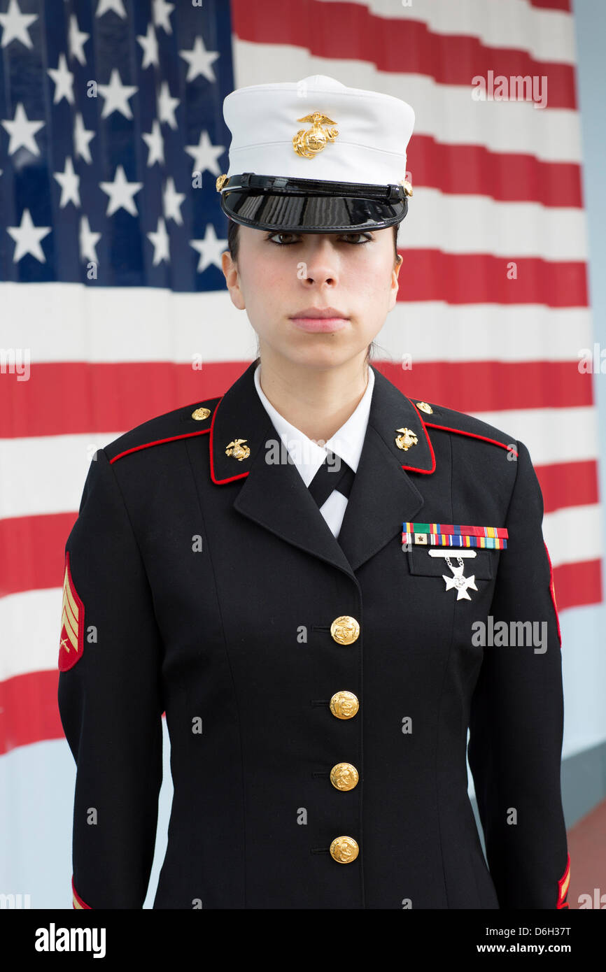 Servicewoman in dress blues by US flag Stock Photo