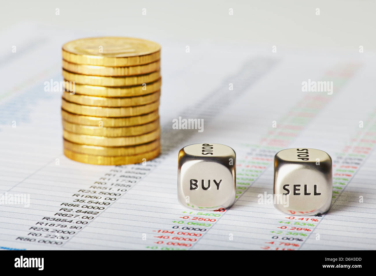financial charts, golden coins and dice cubes with words Sell Buy. Selective focus Stock Photo