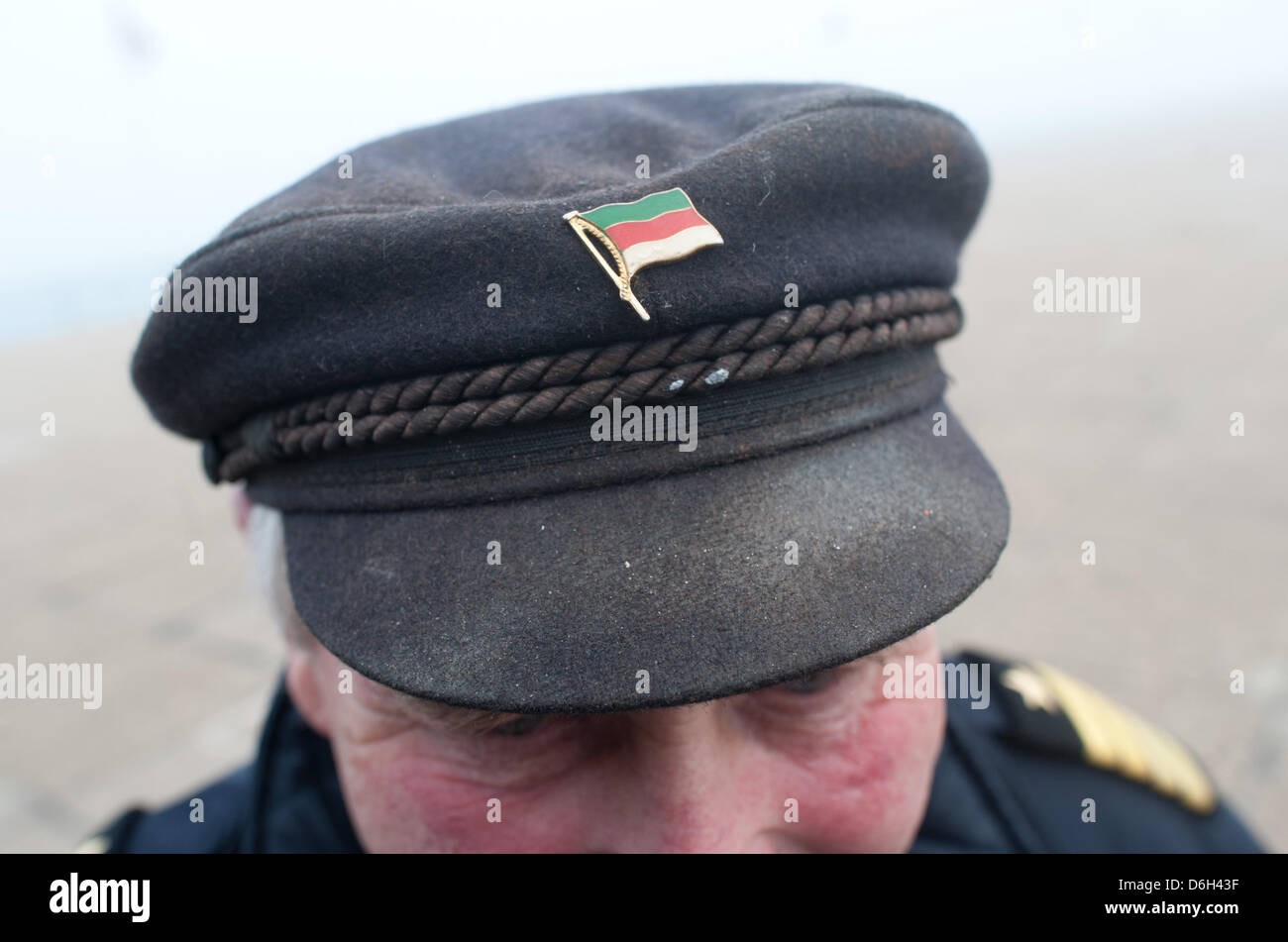 A tiny flag decorates the hat of captain Karl-Heinz Hottendorf in Heligoland, Germany, 01 March 2012. A ceremony was held to celebrate the 60th anniversary of the island's restoration to Germany. On 01 March 1952 the British restored the island to German authorities. Photo: CHRISTIAN CHARISIUS Stock Photo