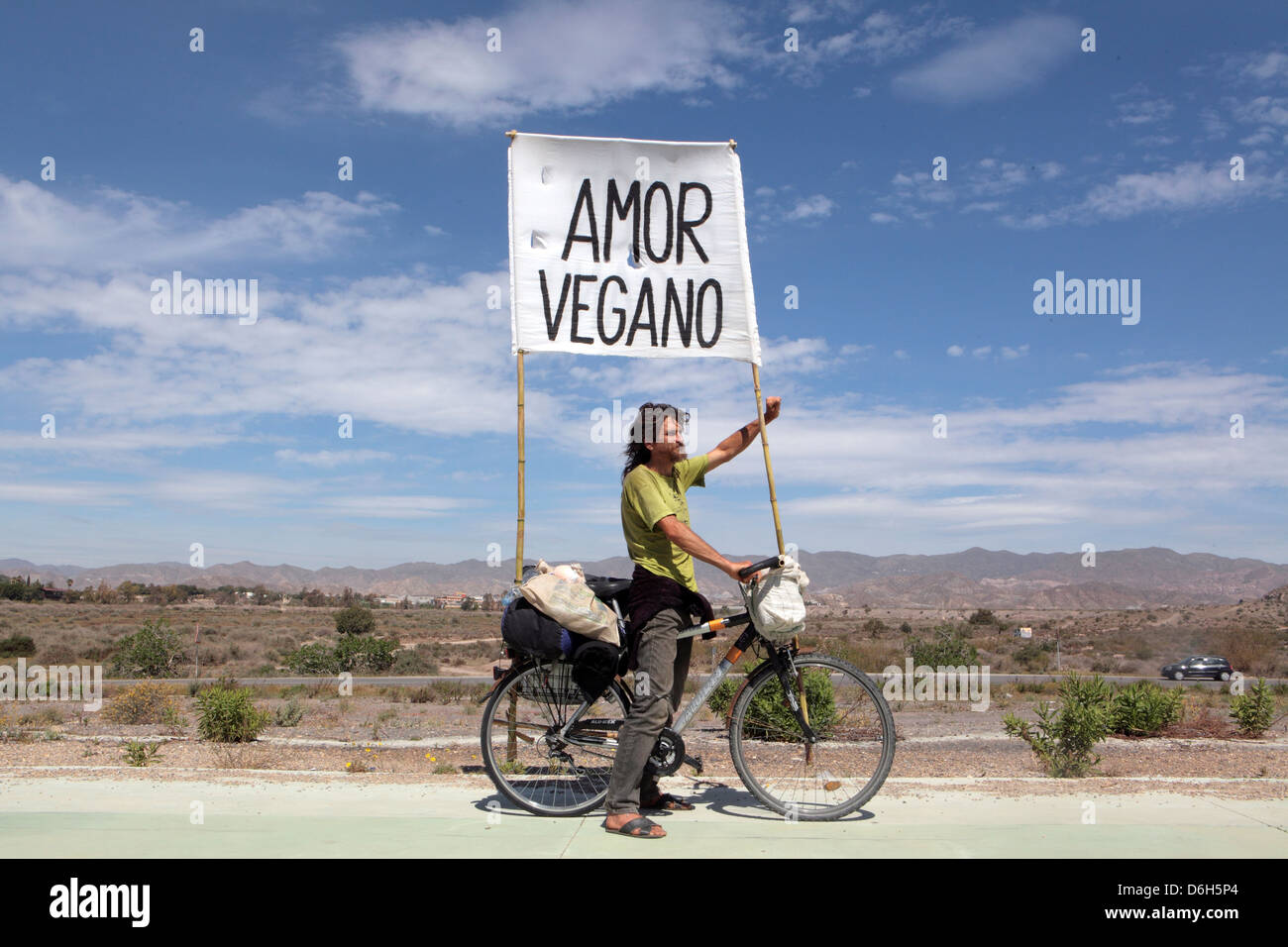 "Amor Vegano" idealistic cyclist carrying banner through Spain promoting vegan vegetarian diet lifestyle, Murcia, Spain, Europe Stock Photo