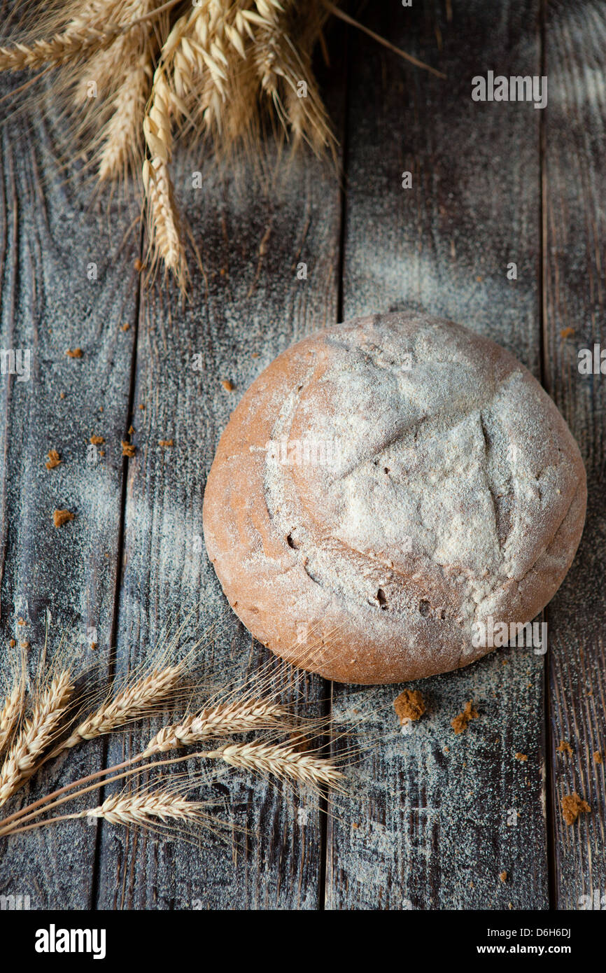 round bread and wheat ears on top view, closeup Stock Photo - Alamy