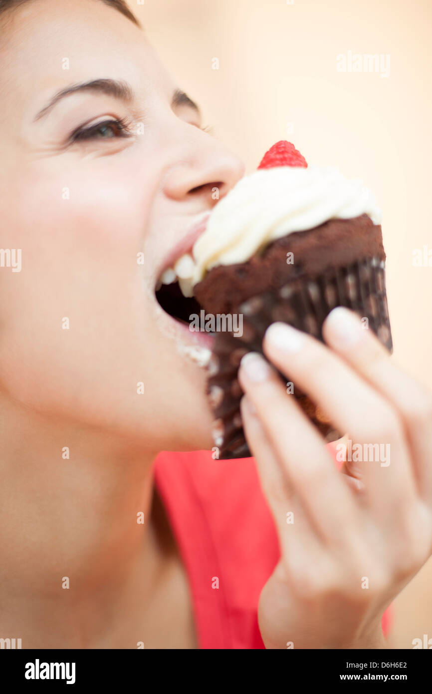 Woman eating a cup cake Stock Photo