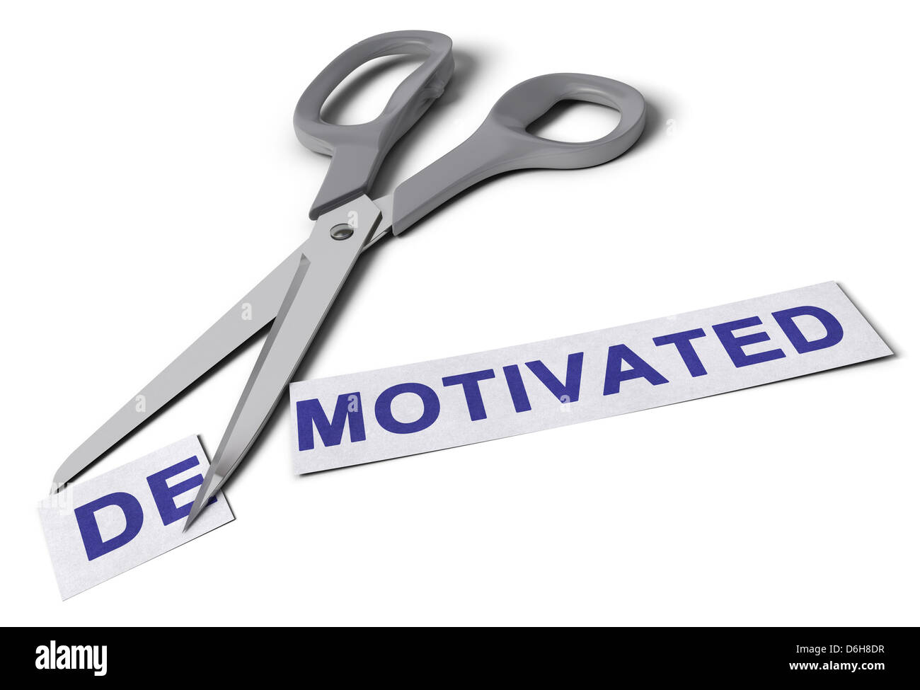 Scissors cut the word demotivated in two parts, the first one with the