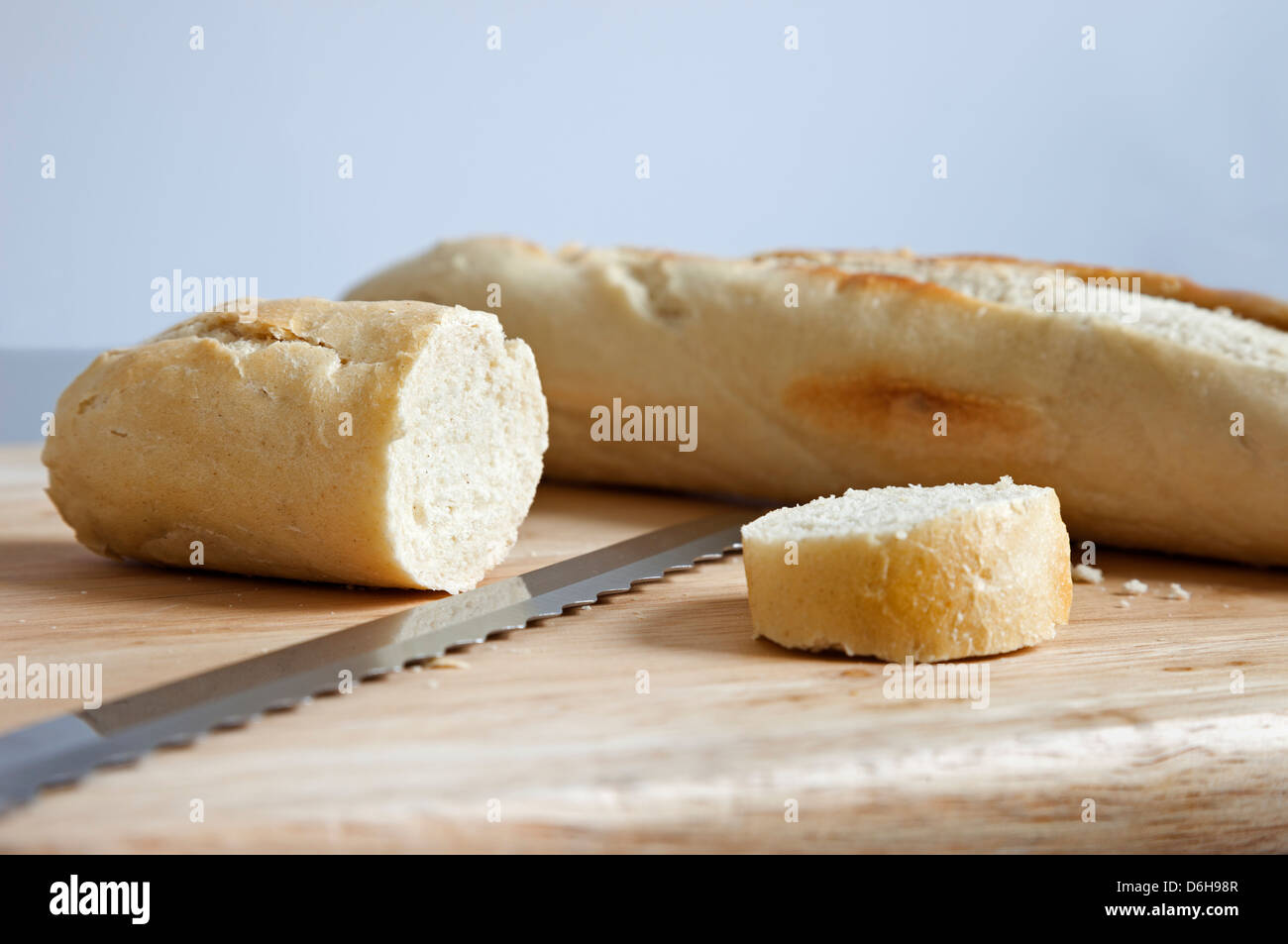 Cut Baguette with Knife on a Bread Board Stock Photo Alamy