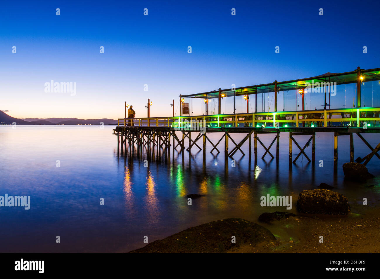 Pier of Ostradamus Restaurant at Ribeirao da Ilha Beach at dusk. Stock Photo