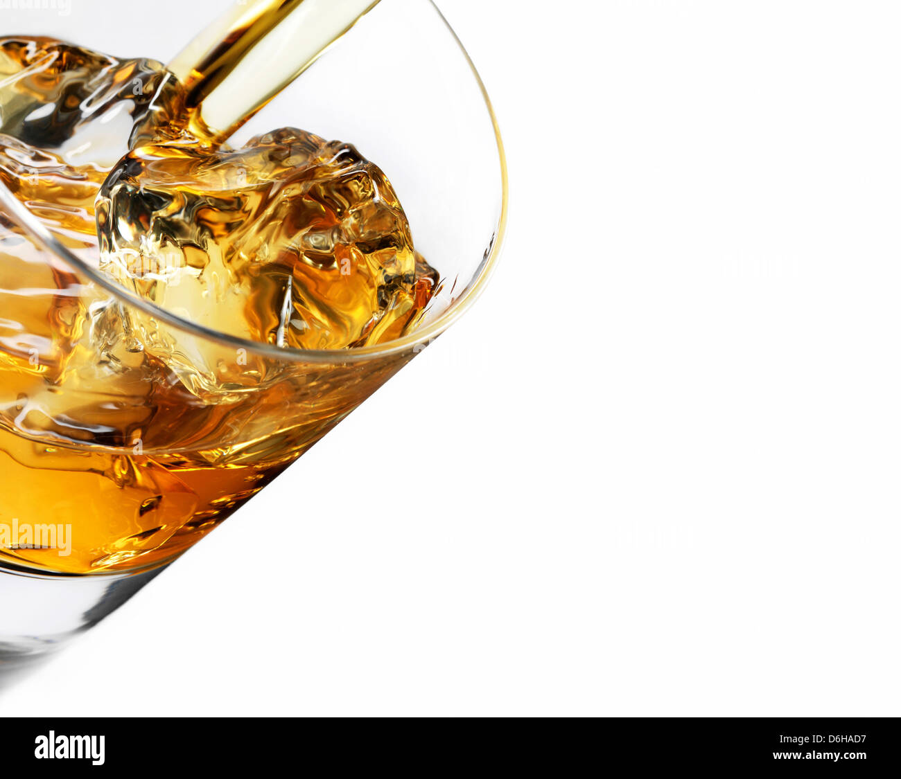 Whiskey over ice pouring into glass Stock Photo Alamy