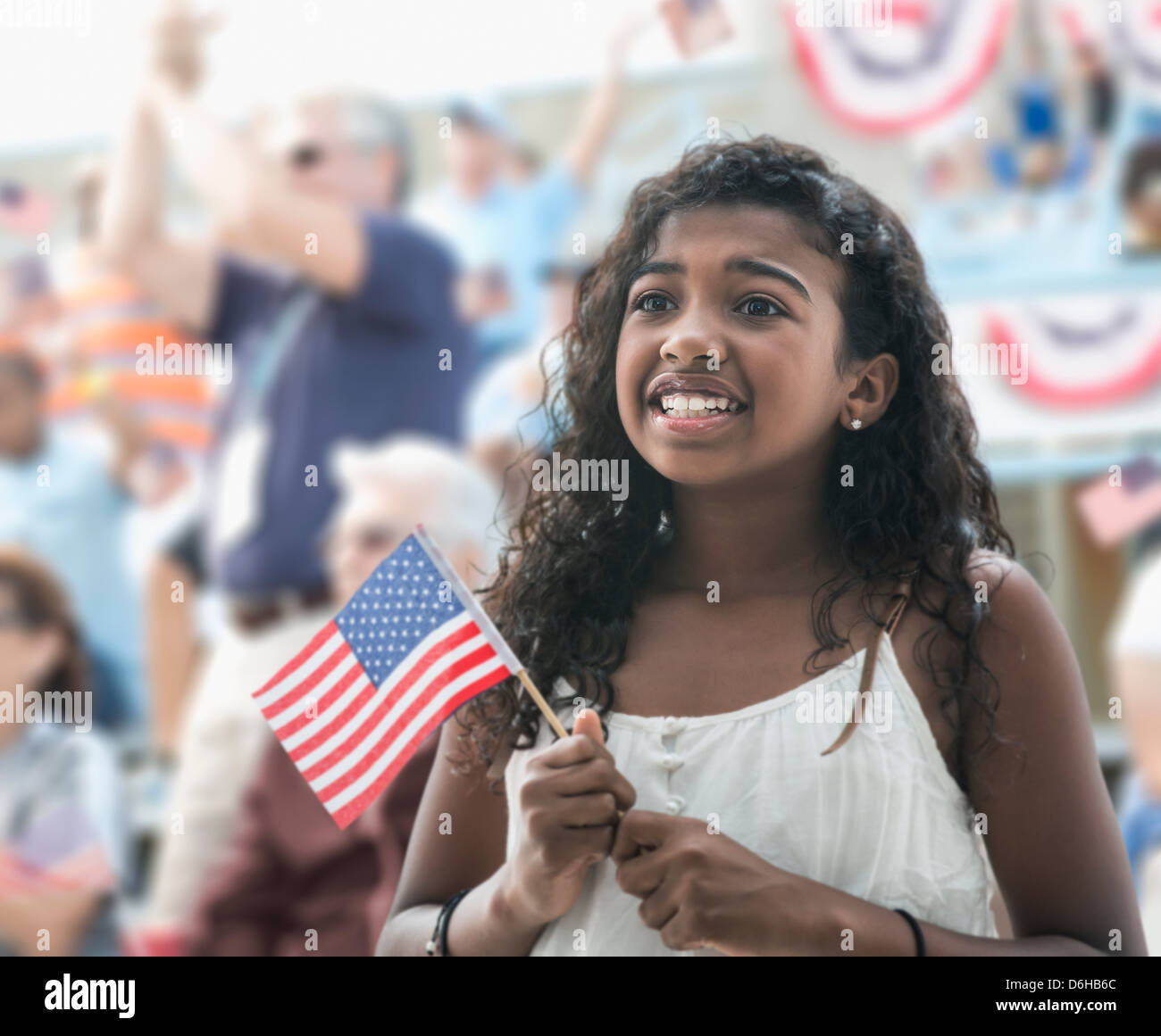Girl holding american flag, looking anxious Stock Photo - Alamy