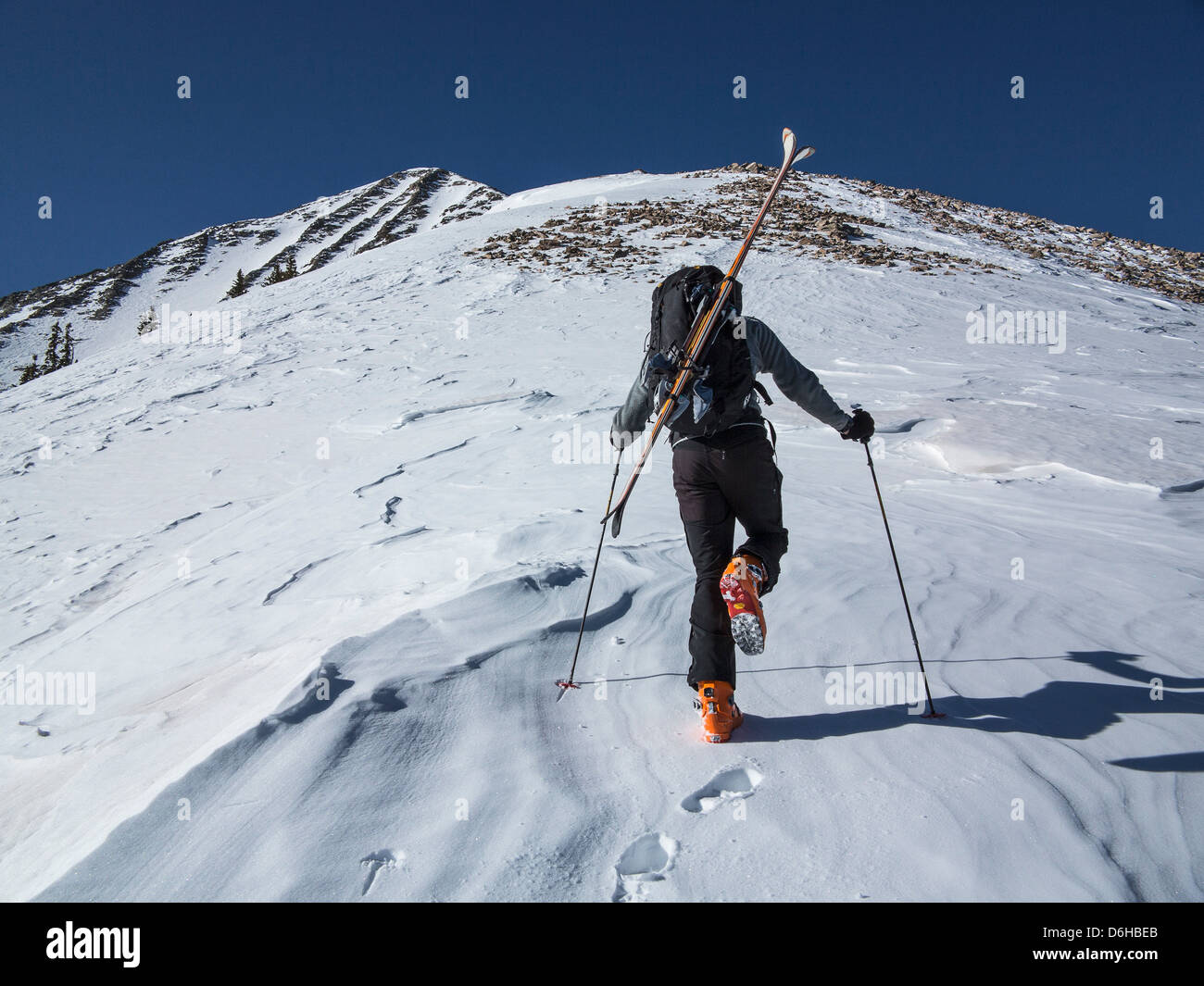 Cross country skier hiking up slope Stock Photo Alamy