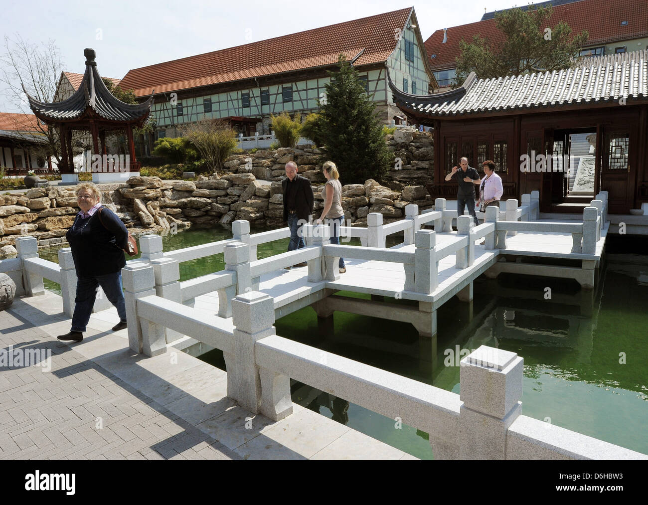 The first visitors walk through the Chinese Garden in Weissensee, Germany, 18 April 2013. The garden, one of the largest Chinese gardens in Germany with 5,000 square meters, opened in 2011 and received 50,000 visitors last year. Photo: BERND SETTNIK Stock Photo