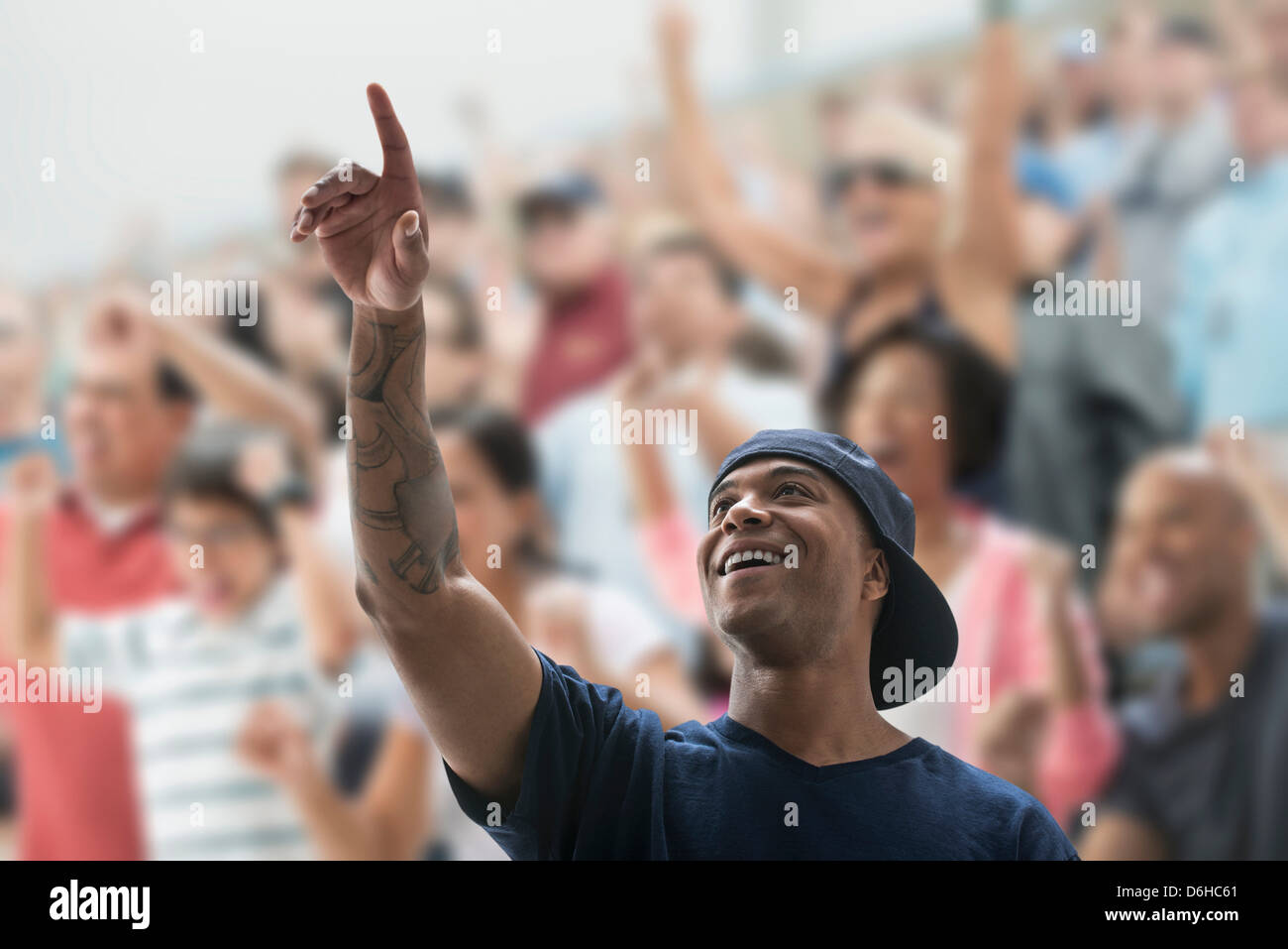 Man at sports game, pointing up Stock Photo - Alamy