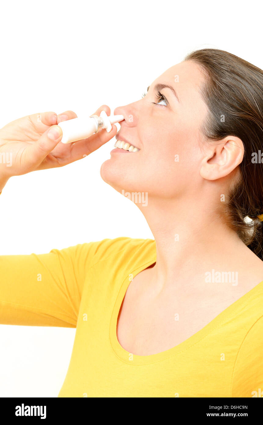 Young woman using nasal spray Stock Photo