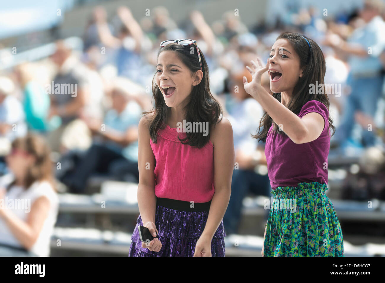 Two excited girls at a pop concert Stock Photo