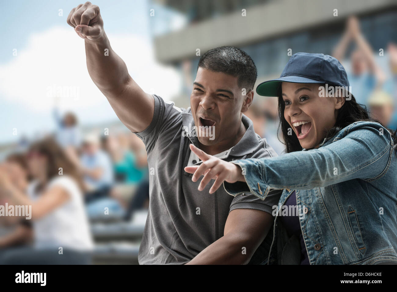 Excited couple at sports game Stock Photo