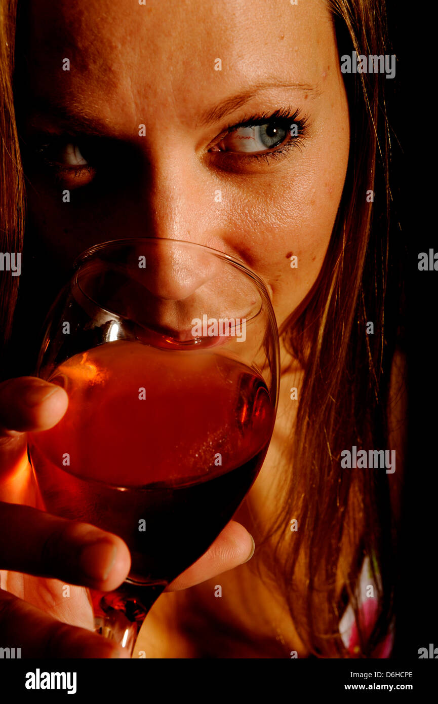 A young Blonde woman drinking a glass of red wine in a bikini Stock ...