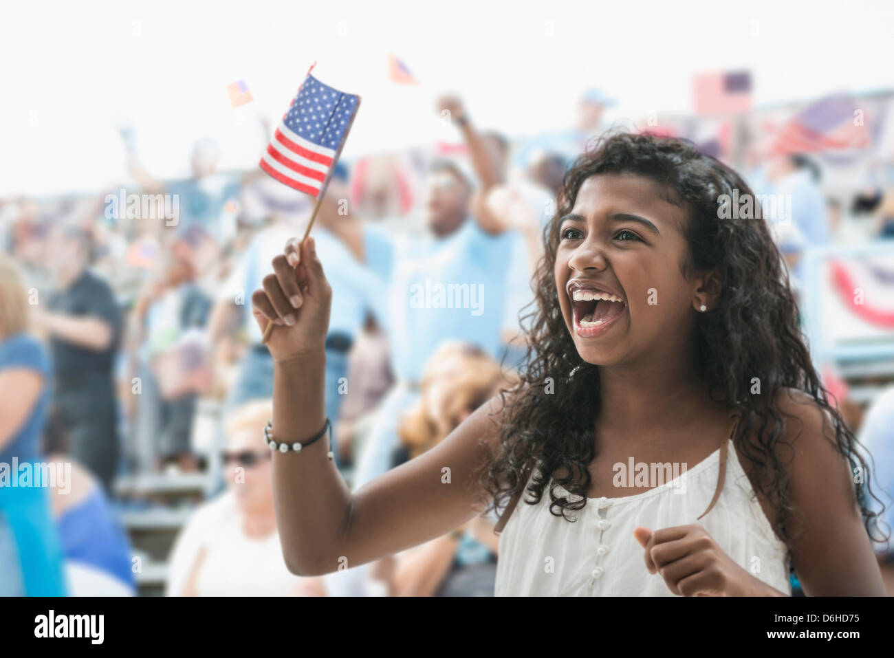 Girl cheering and waving american flag Stock Photo Alamy