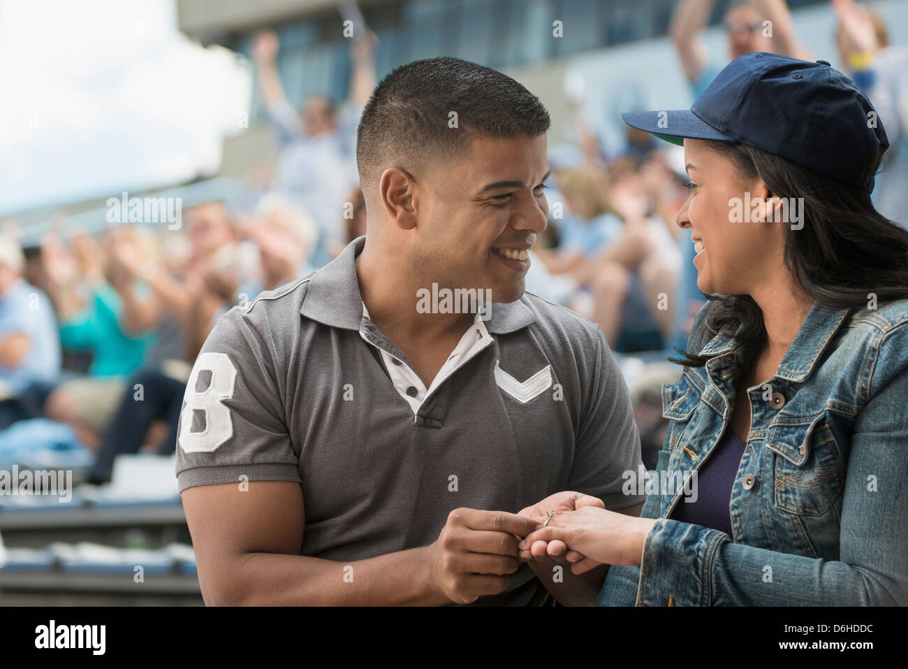 Couple getting engaged at sports game Stock Photo Alamy Couple getting engaged at sports game Stock Photo Alamy