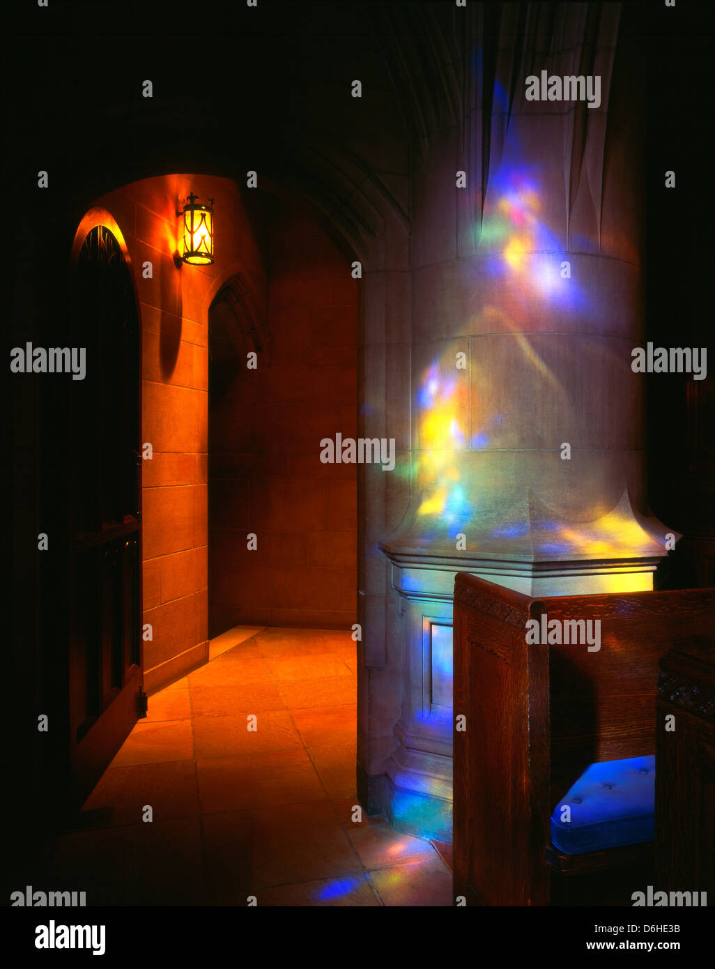 Dappled sunlight through stained glass windows casts colorful patterns