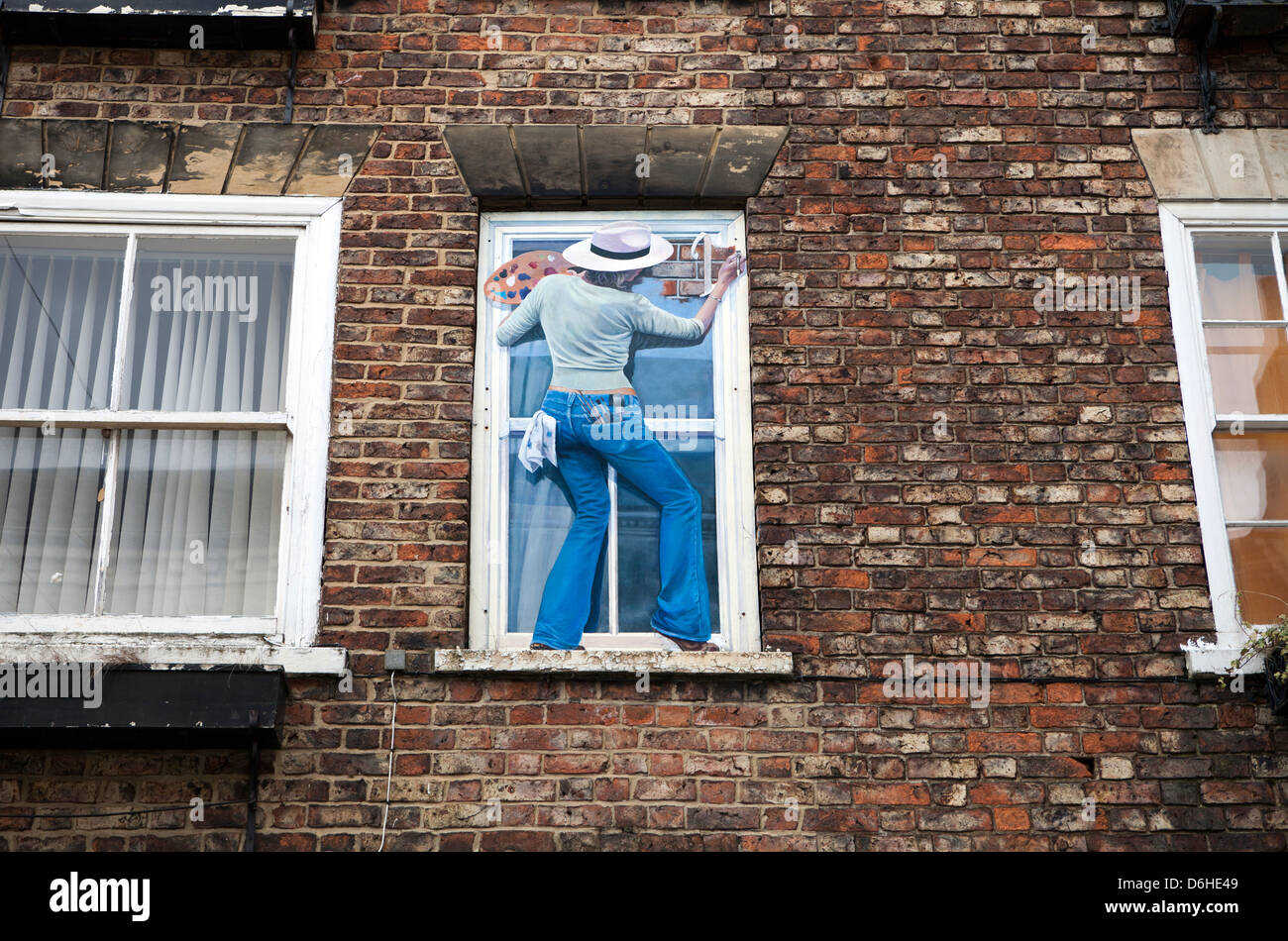 painting on the facade of a building where a window was bricked up to avoid the window tax of 1696-1851 Stock Photo