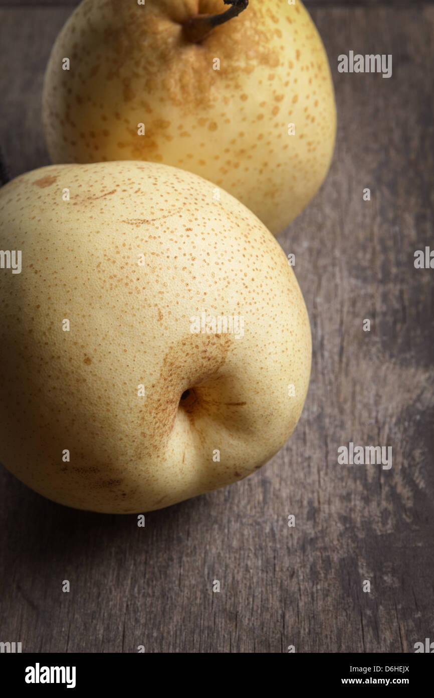 two asian ripe yellow pears on old wooden table, selective focus Stock ...