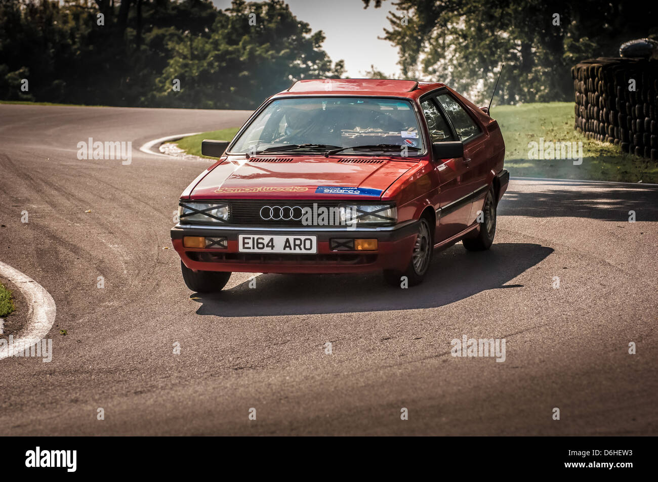 Old red Audi car racing at Cadwell park race track. Stock Photo