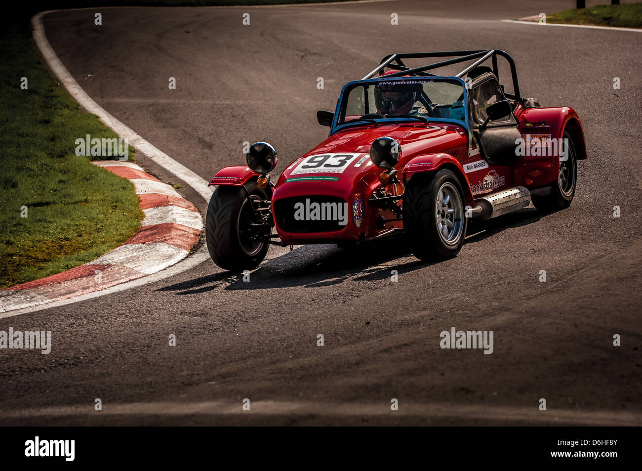 Red Caterham Seven sports car on Cadwell Park race track. Stock Photo