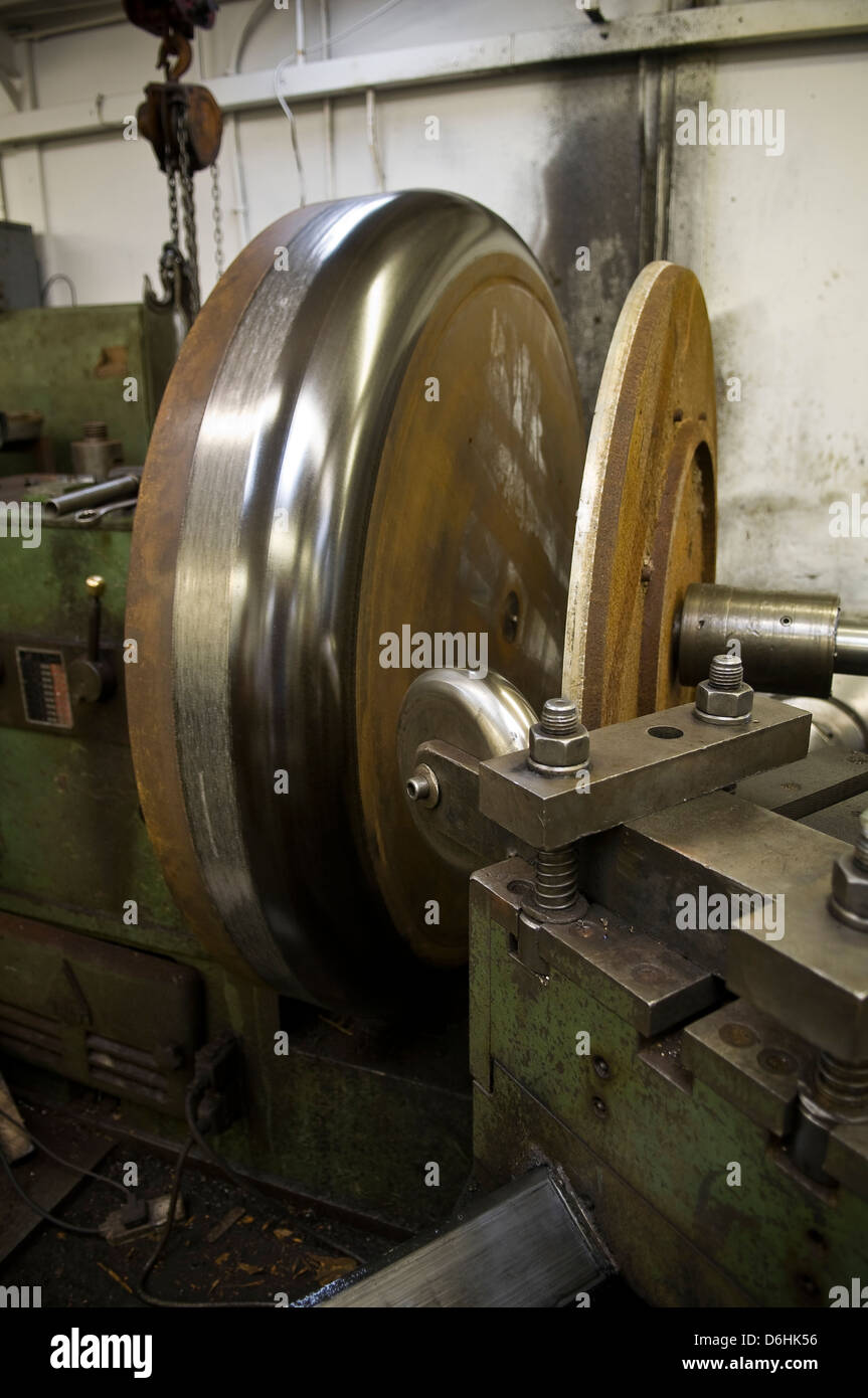 Industrial lathe and former used for metal spinning process Stock Photo