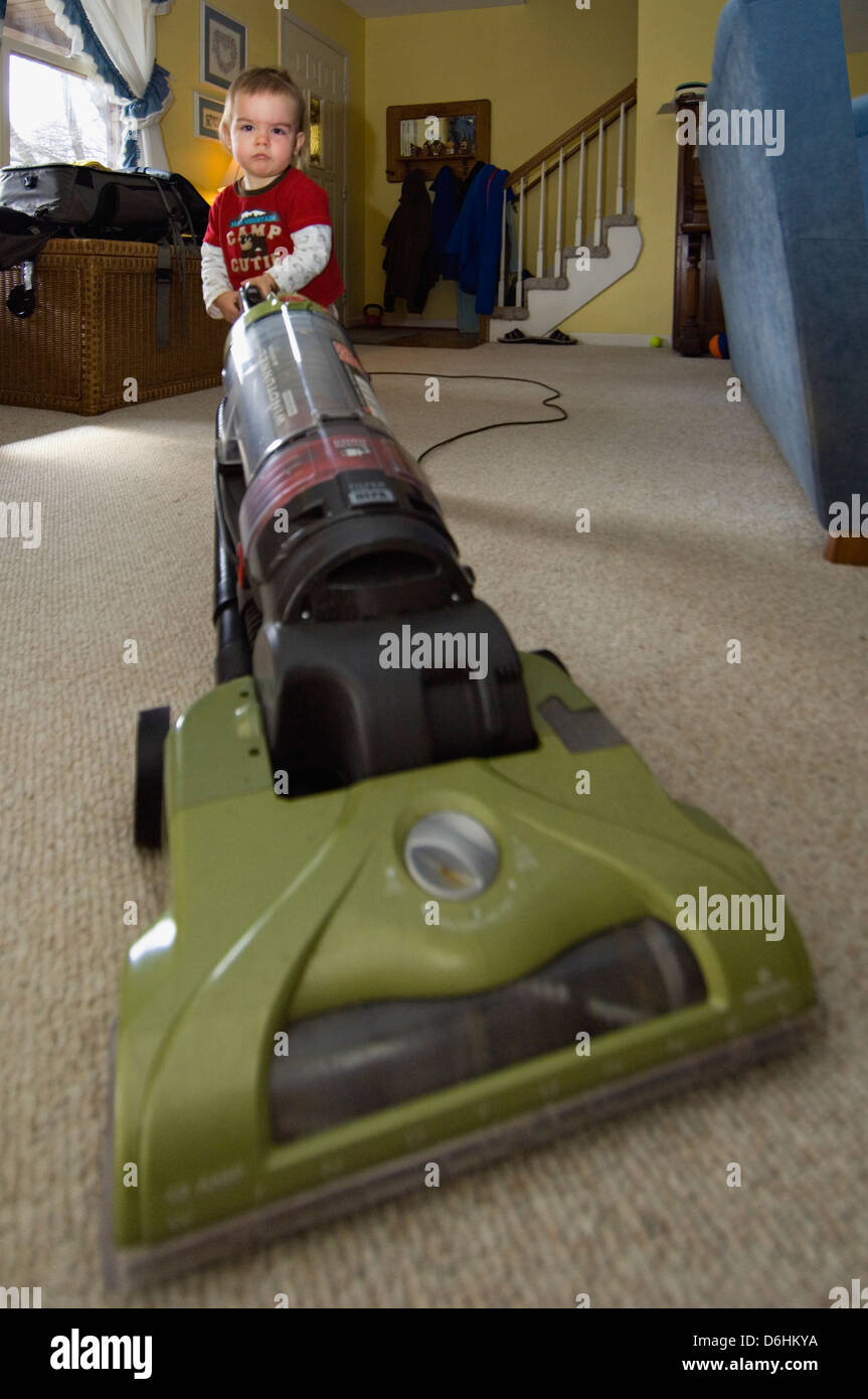 One and a Half Year Old Boy Playing with Vacuum Stock Photo