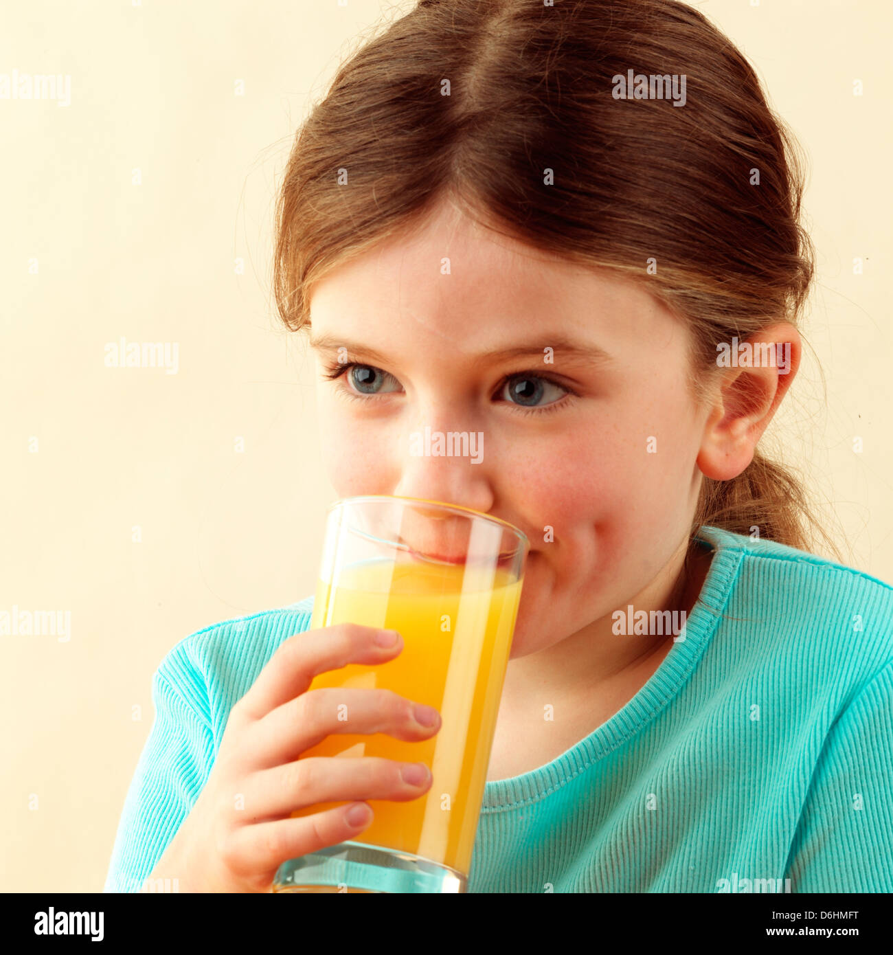Girl drinking orange juice Stock Photo - Alamy