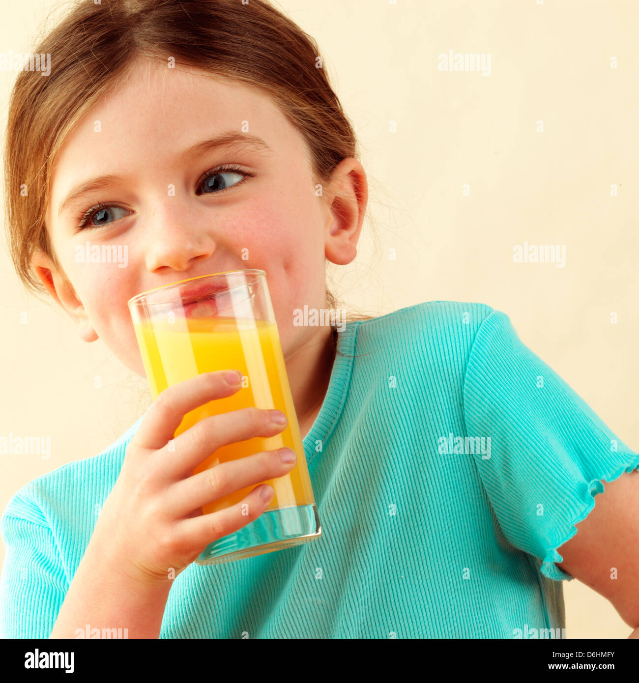 Girl drinking orange juice Stock Photo