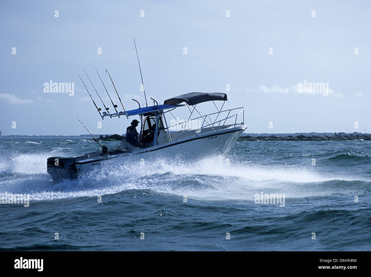 Offshore sport fishing boat running through rough water