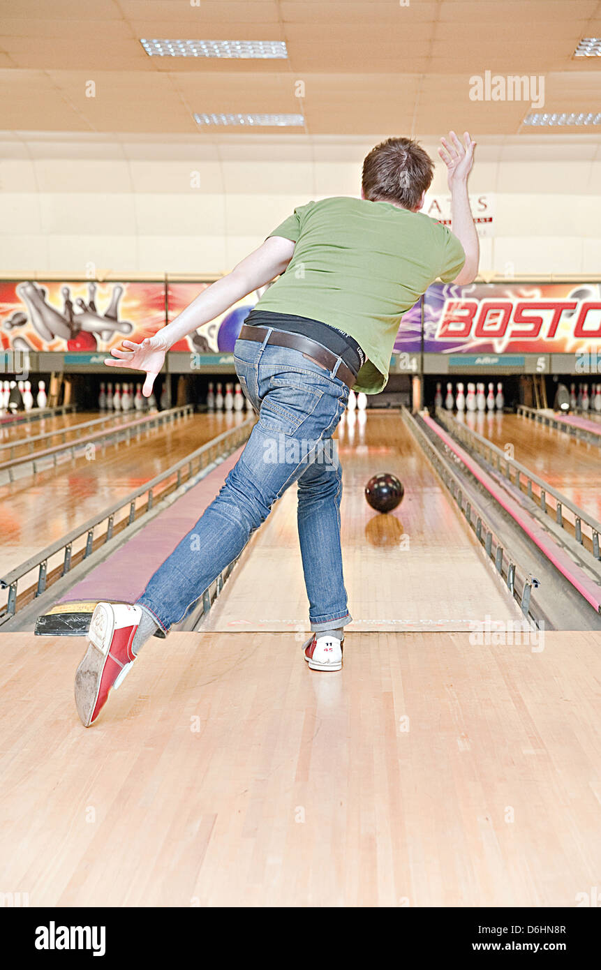 A young male bowling at the local bowling alley Stock Photo