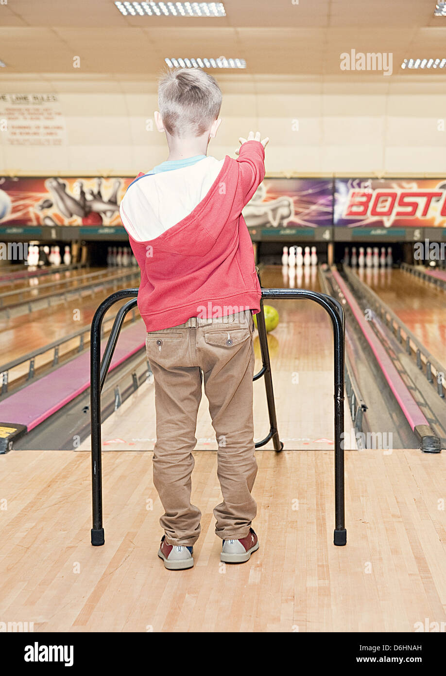 A young boy using a bowling ramp Stock Photo - Alamy