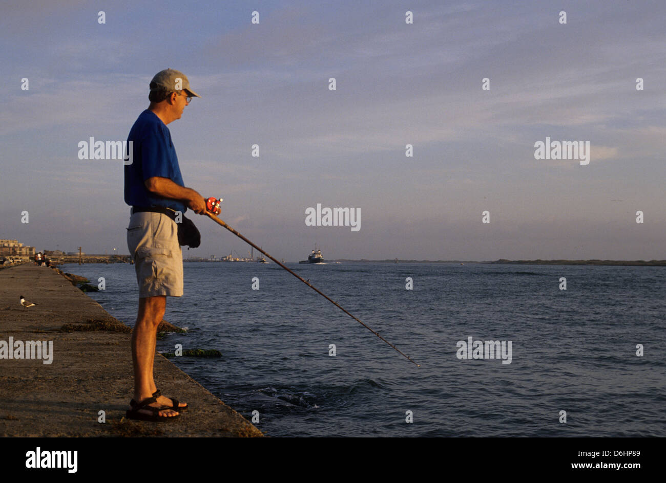 Man fishing from the jetties at Port Aransas Texas Stock Photo Alamy