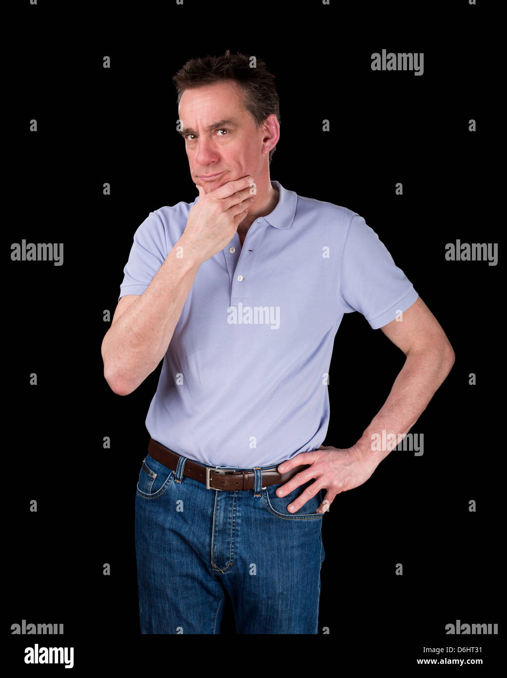 Thoughtful Middle Age Man Considering Something Hand on Hip Black Background Stock Photo
