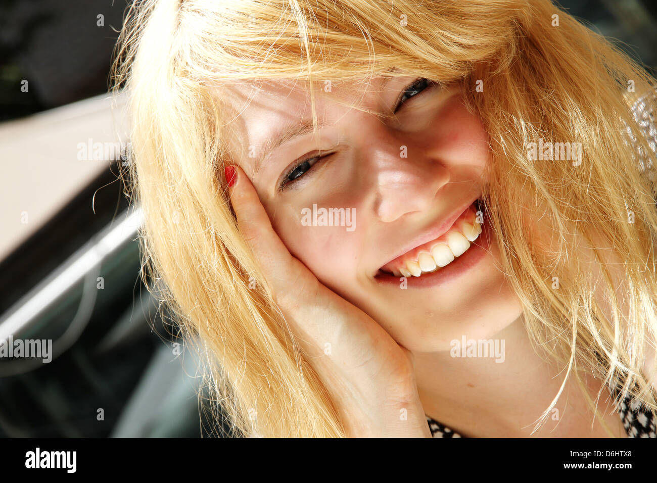 A smiling young woman in the sunlight Stock Photo - Alamy