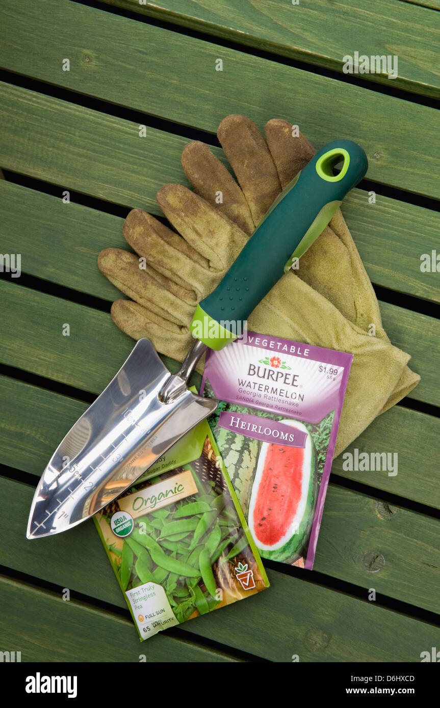 Burpee Organic and Heirloom Seed Packets with Garden Gloves and Hand Trowel Stock Photo