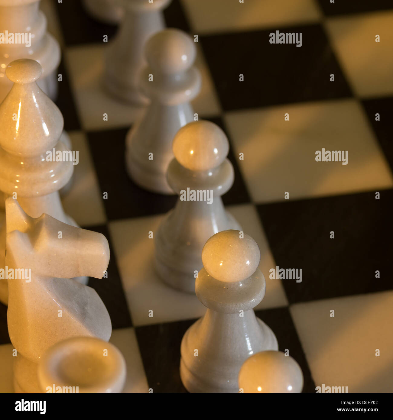 Dramatic closeup of chess board and pieces. Metaphor for teamwork